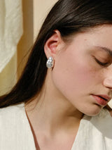 The breath of the sea lingers by your ear